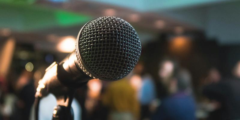 Illustration with a microphone on stage. 